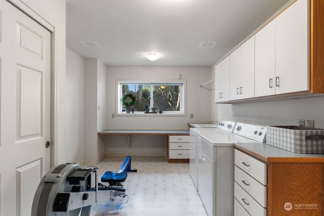 washroom featuring cabinet space, washing machine and dryer, visible vents, and light floors