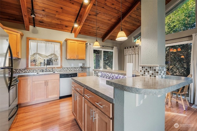 kitchen with sink, stainless steel appliances, a center island, lofted ceiling with beams, and wooden ceiling