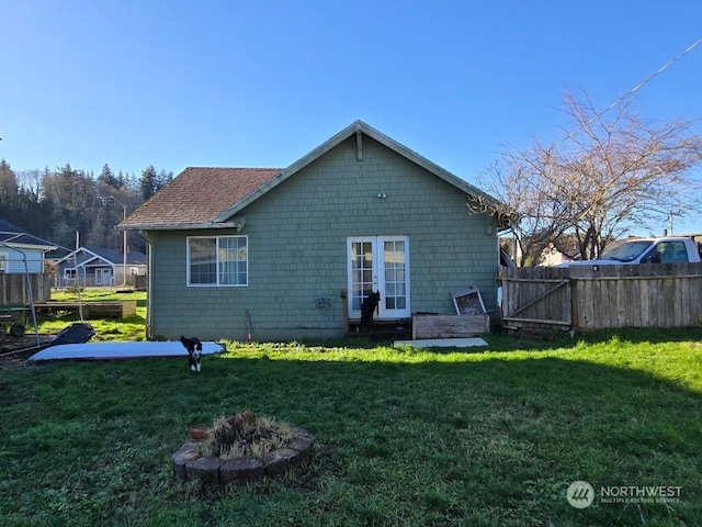 back of house with a lawn