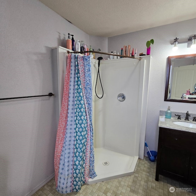 bathroom featuring vanity, a textured ceiling, and a shower with curtain