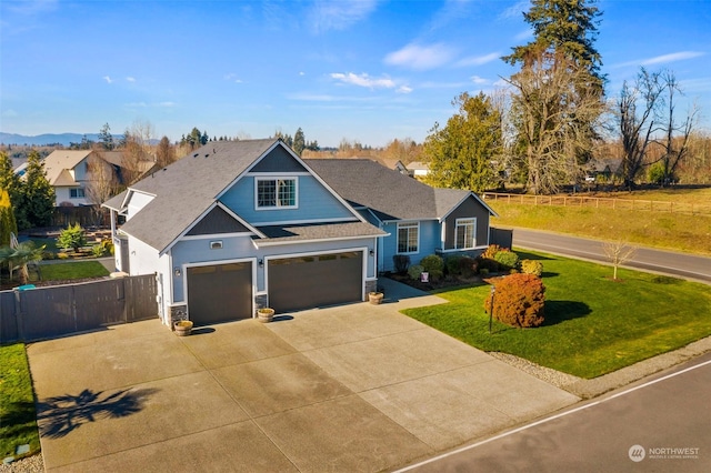 view of front of property featuring a garage and a front yard