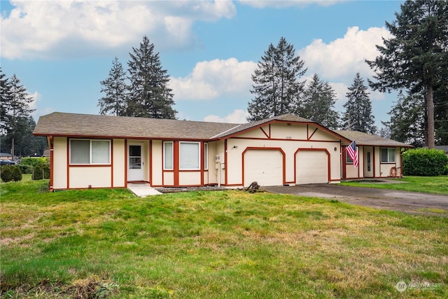 ranch-style house featuring a garage and a front lawn