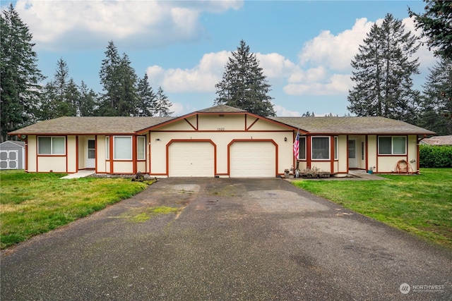 single story home with a garage and a front lawn