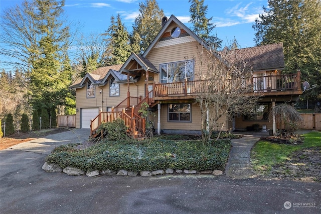 view of front of house with a garage and a wooden deck