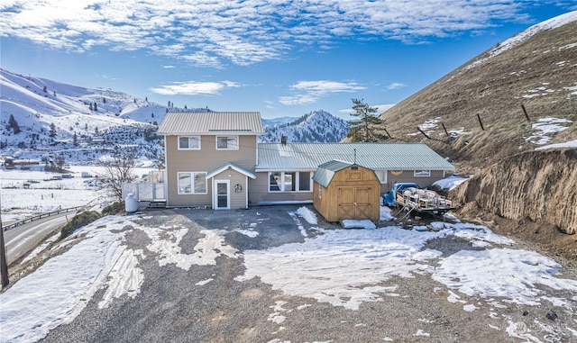 view of front facade with a shed and a mountain view