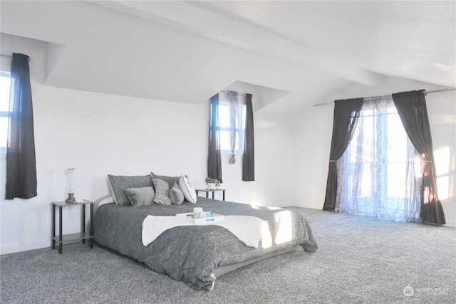 carpeted bedroom with lofted ceiling with beams