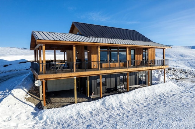 snow covered property with a wooden deck