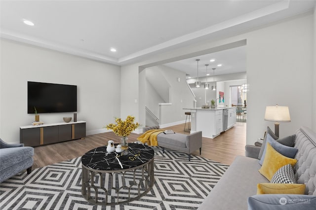 living room featuring an inviting chandelier and dark hardwood / wood-style flooring