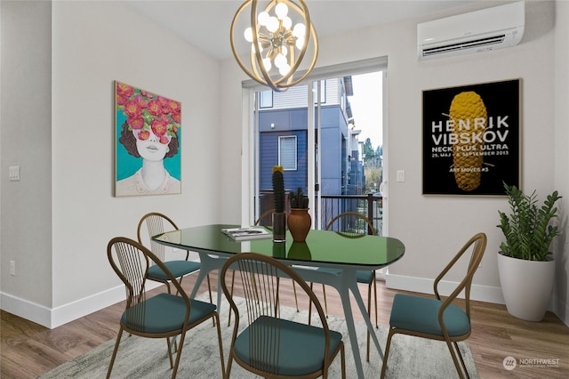 dining space with hardwood / wood-style floors, a wall unit AC, and a notable chandelier