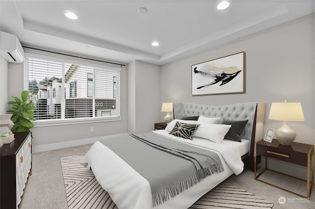 carpeted bedroom featuring a raised ceiling and an AC wall unit