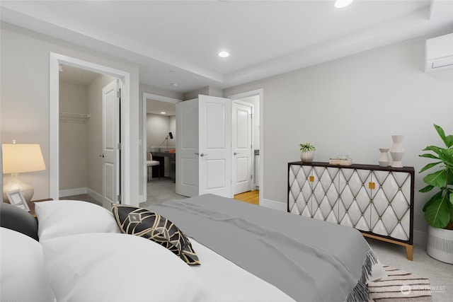 bedroom with light carpet, a spacious closet, a closet, and a wall mounted AC