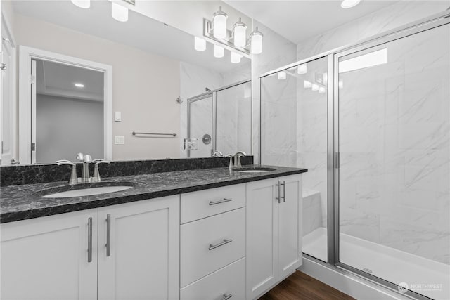 bathroom featuring a shower with door, vanity, and hardwood / wood-style flooring