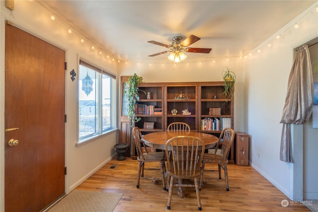 dining space featuring light wood-type flooring, ceiling fan, and baseboards