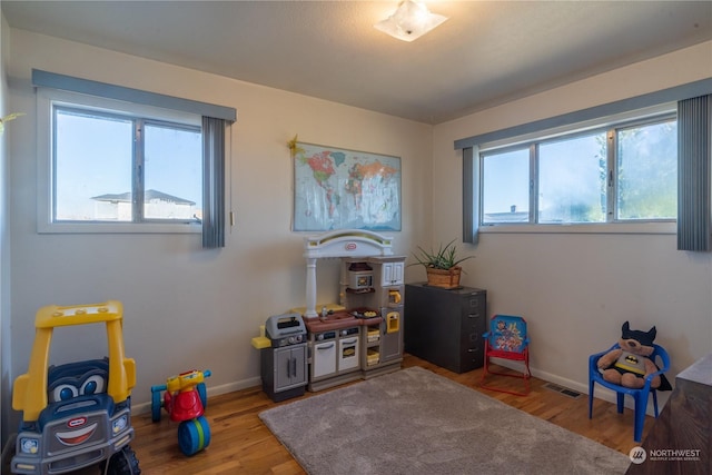 rec room featuring wood finished floors and baseboards