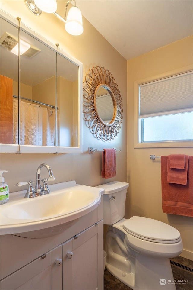 full bath featuring visible vents, vanity, and toilet