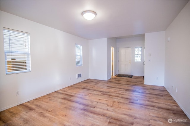 unfurnished room featuring light hardwood / wood-style floors