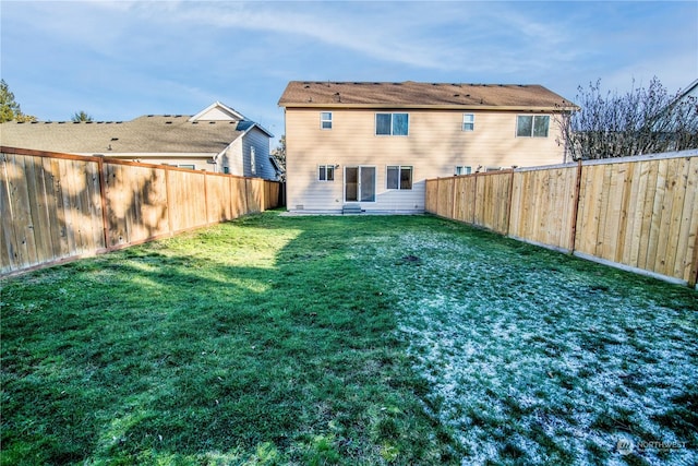 rear view of property featuring a yard