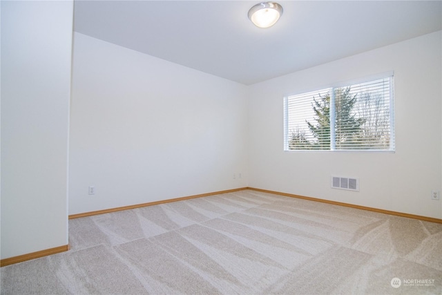 empty room featuring light carpet