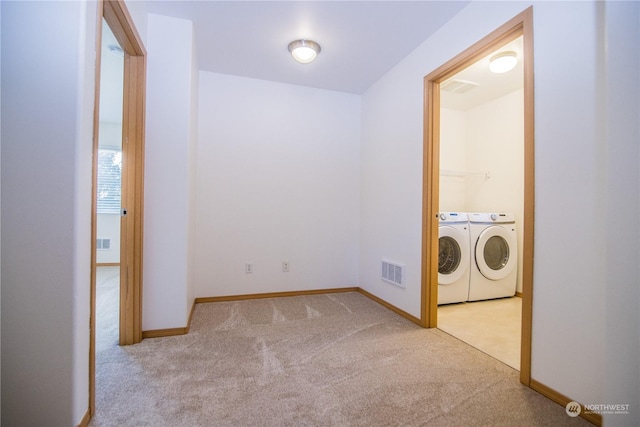 laundry area with light colored carpet and washing machine and clothes dryer