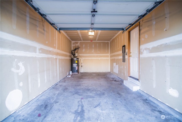 garage featuring electric panel and water heater