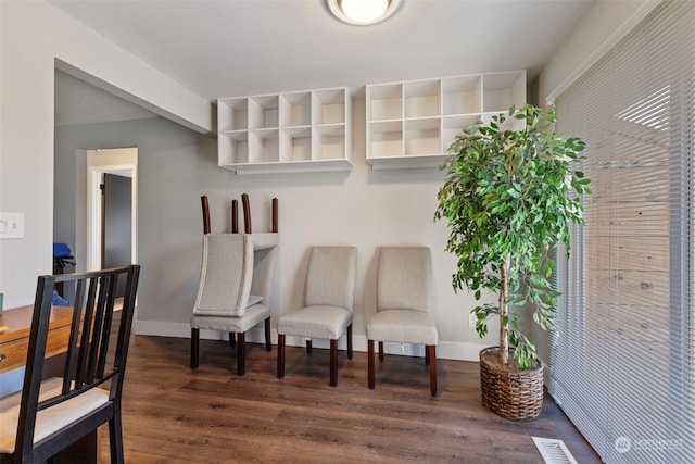 sitting room with dark hardwood / wood-style flooring