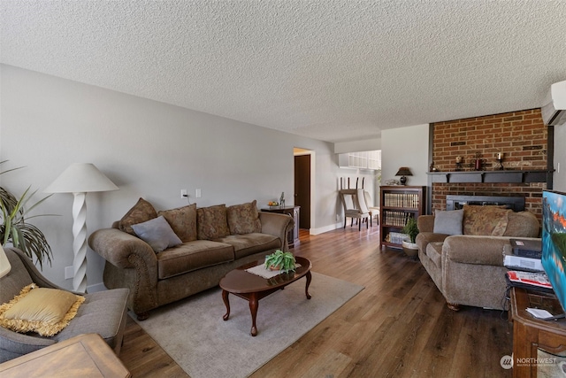 living room with a fireplace, dark wood-type flooring, and a textured ceiling