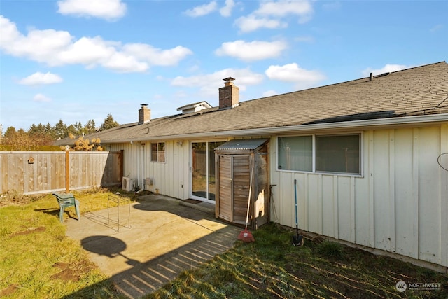 rear view of property with a patio and a yard