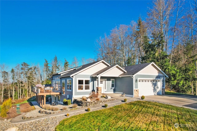 view of front of house featuring a garage and a front lawn