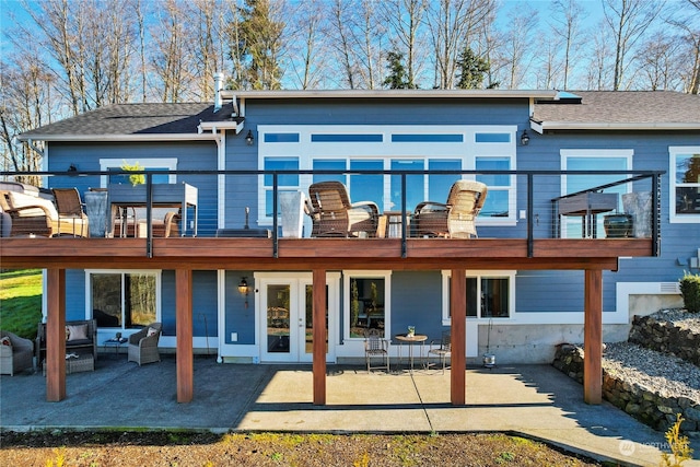 rear view of house featuring french doors, a balcony, outdoor lounge area, and a patio area