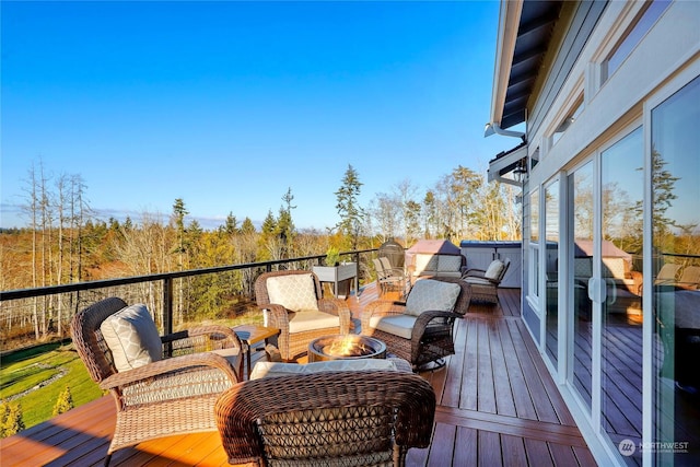 wooden terrace with an outdoor fire pit