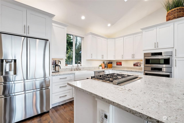 kitchen featuring light stone counters, sink, white cabinetry, and appliances with stainless steel finishes