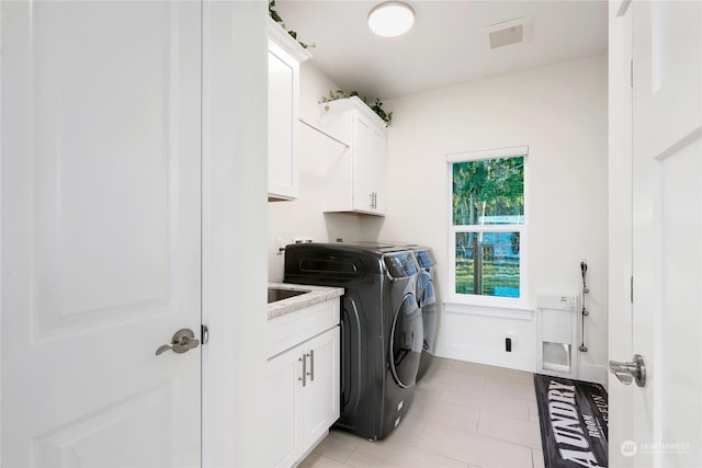 laundry area with cabinets and separate washer and dryer