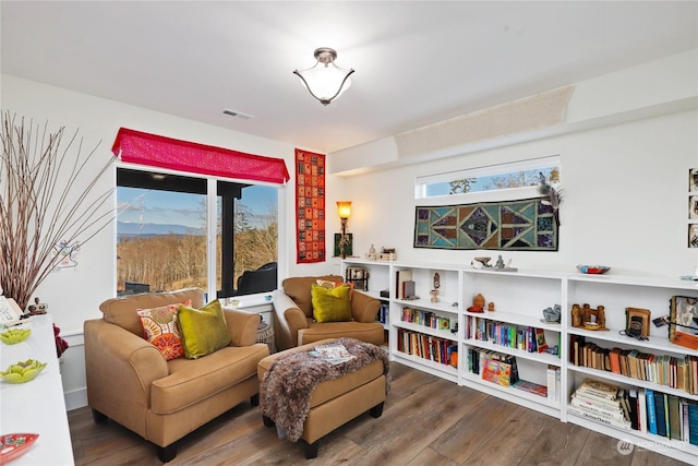 living area with hardwood / wood-style flooring