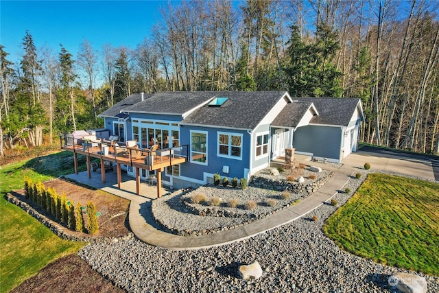 rear view of house featuring a deck