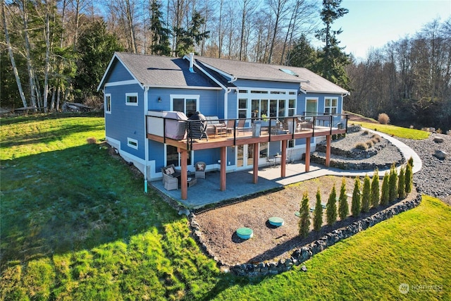 rear view of house with a yard, a patio area, and a deck