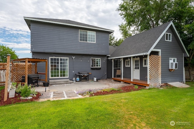 back of property featuring a yard, an outdoor structure, and a patio