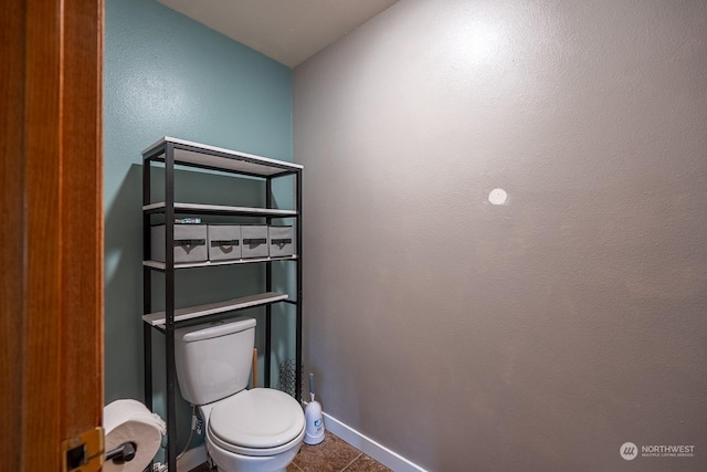 bathroom with toilet and tile patterned flooring