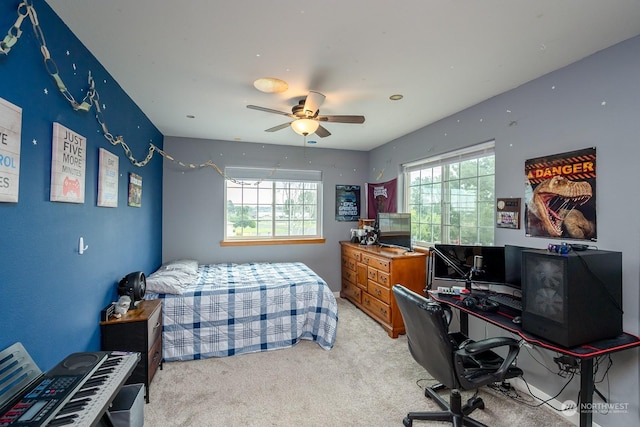 carpeted bedroom with ceiling fan and multiple windows