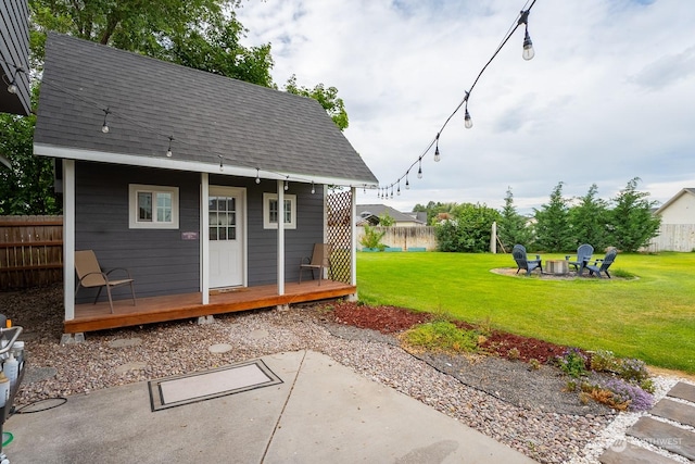 view of outbuilding featuring a yard and a fire pit