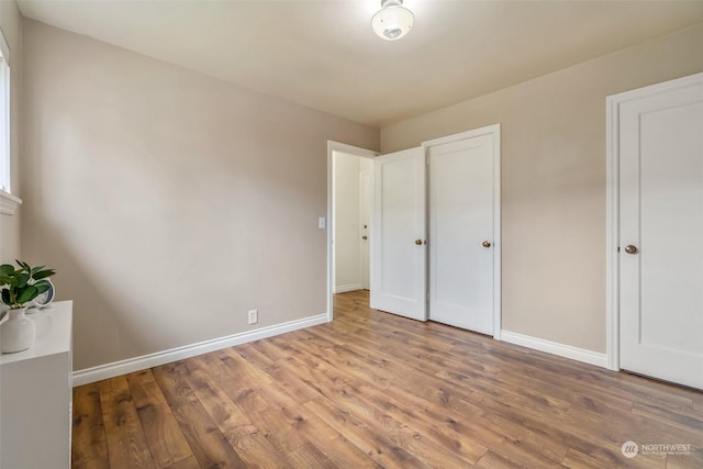 unfurnished bedroom with wood-type flooring