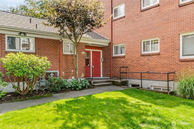 property entrance with a lawn