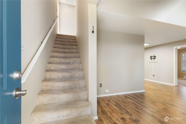 stairs with hardwood / wood-style floors