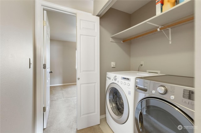 laundry area featuring washing machine and clothes dryer