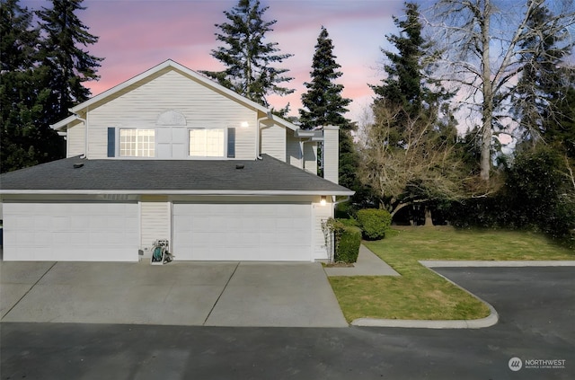 view of front of property featuring a garage and a yard