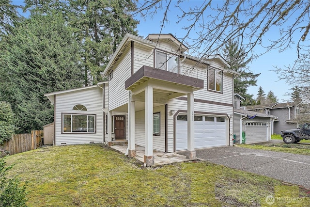 traditional home featuring aphalt driveway, an attached garage, a balcony, fence, and a front lawn