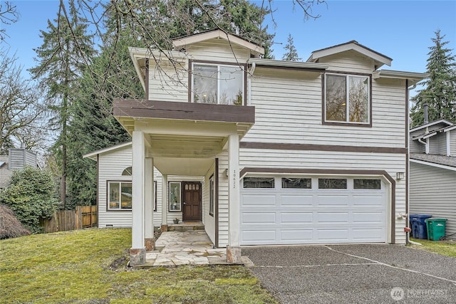 traditional home with a garage, driveway, crawl space, fence, and a front lawn