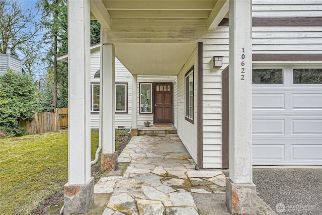 doorway to property featuring fence