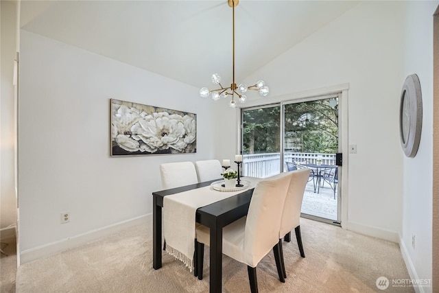 dining area with a notable chandelier, high vaulted ceiling, baseboards, and light colored carpet