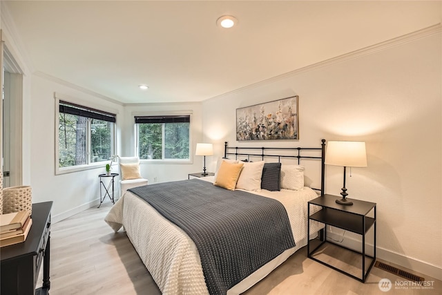 bedroom featuring light wood-style flooring, ornamental molding, baseboards, and recessed lighting