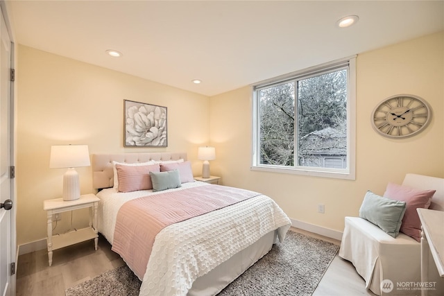 bedroom featuring baseboards, wood finished floors, and recessed lighting